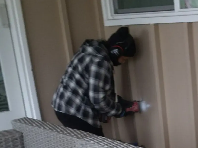 Professional electrician installing an exterior outlet in Plains
